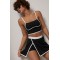 Спортивный костюм женский с топом и юбкой-шортами Lurex